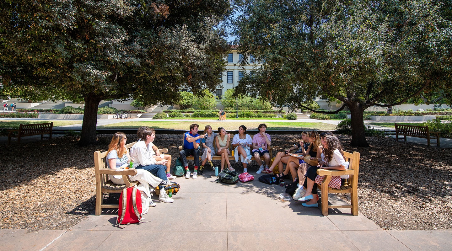 A group of «Ӱҵ students lined up on three benches facing each other on the Quad